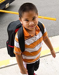 Photo of young boy wearing a backpack